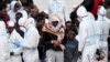 ITALY -- Migrants wait to disembark from Italian Coast Guard vessell "Diciotti" as it docks at the Sicilian port of Catania, southern Italy, Wednesday, June 13, 2018